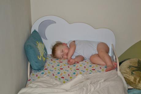 HelloHome StarBright toddler bed and a child sleeping sideways