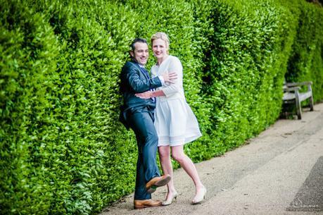 bride gives groom helpful push into hedge