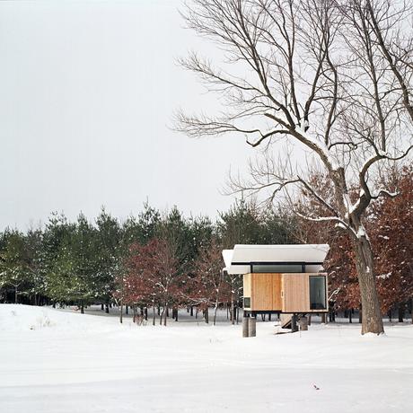 In the winter, instead of floating over the pond, the hut sits lightly above the snow. 