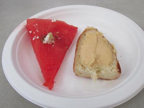 Beer cheese on a pretzel roll with a slice of watermelon with feta from New World Cheese.