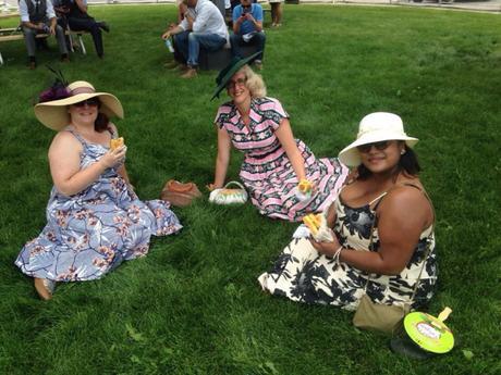 Refined ladies eating hotdogs in the grass ... Classy!