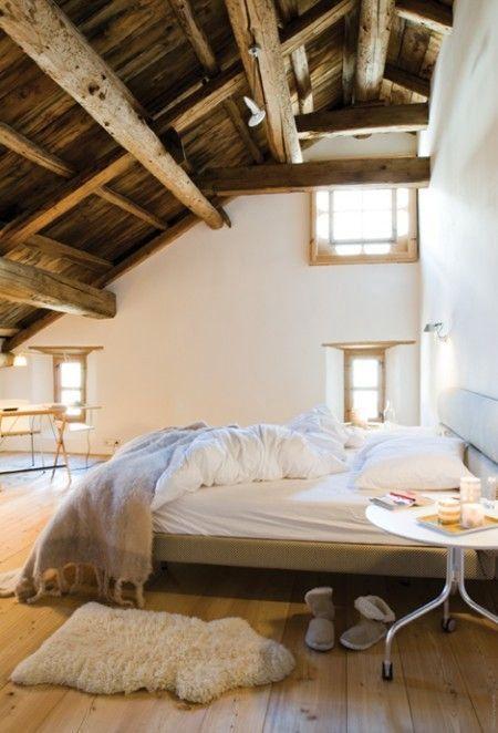old attic room with hand stacked wooden beams