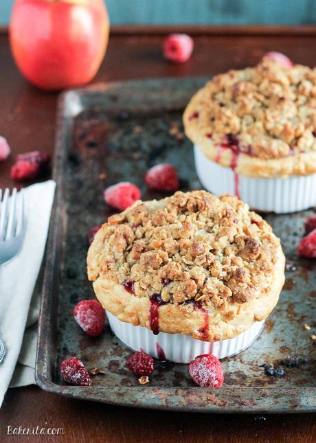 These Mini Apple Berry Crumble Pies are bursting with tart, juicy berries and tender apple slices, topped with a delectably crunchy crumble topping! Serve with ice cream for the best treat.