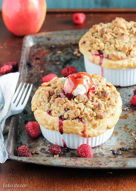 These Mini Apple Berry Crumble Pies are bursting with tart, juicy berries and tender apple slices, topped with a delectably crunchy crumble topping! Serve with ice cream for the best treat.