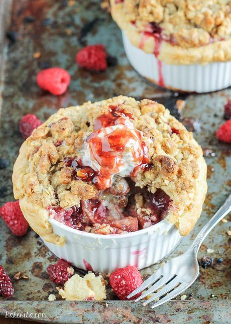 These Mini Apple Berry Crumble Pies are bursting with tart, juicy berries and tender apple slices, topped with a delectably crunchy crumble topping! Serve with ice cream for the best treat.