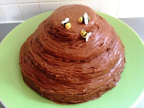 beehive honey cake with hidden chocolate honeycomb center decorated with fondant bees