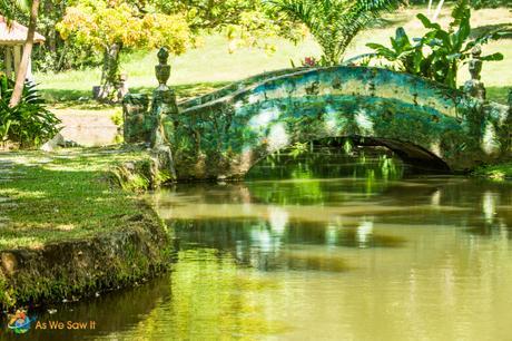 Beautifully decorated bridge over a small section of a turtle filled lake adds to the Botanical Gardens of Summit.