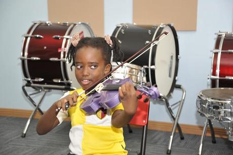 Learning to play the violin at GEMS Cambridge International School Kampala