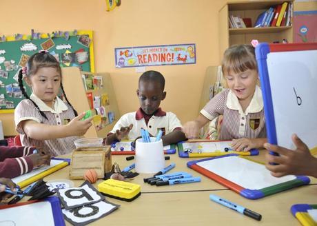 Playing with whiteboards and markers GEMS Cambridge International School Kampala