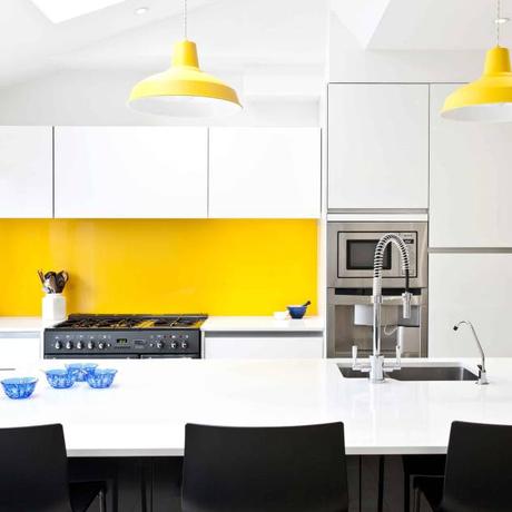 White, black, stainless steel and a vibrant splash of yellow. : Modern kitchen by Pyram