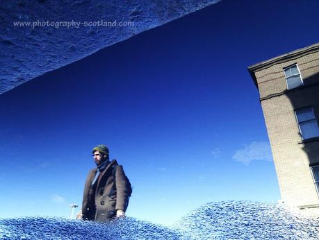 Urban photo - building reflected in a puddle