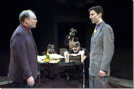 Bret Tuomi as Jeffrey Skilling confronts Sean Fortunato as Andrew Fastow, with his “raptors” (from left: Benjamin Sprunger, Demetria Thomas, and Matt Holzfeind) in the Chicago premiere of ENRON by Lucy Prebble, directed by Rachel Rockwell