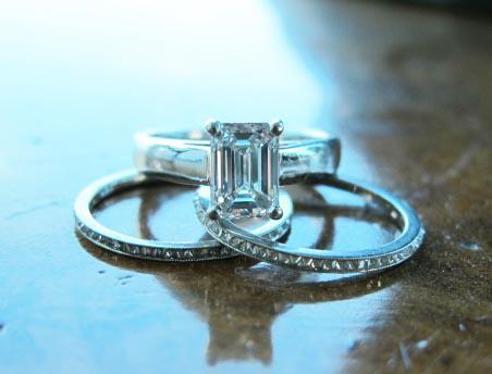 Emerald cut solitaire engagement ring with diamond wedding bands