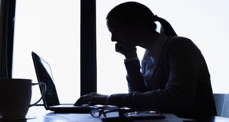 Silhouette of businesswoman using computer