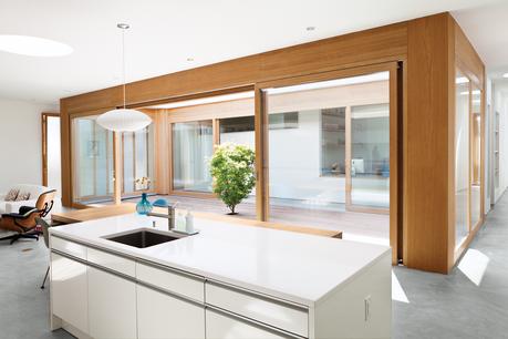 Modern kitchen with white countertops and Eames lounge chair