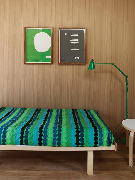 Australian studio with green Marimekko bedding and floor lamp