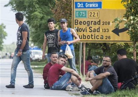 Refugees rest near the border station between Serbia and Hungary in Horgos, Serbia. (Sandor Ujvari/MTI via AP)