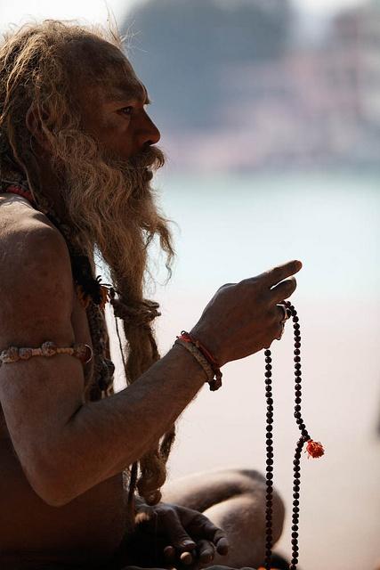 Shiva Raj Giri, Naga baba (naked sadhu) in Haridwar telling mantras with his mala. #Mala has 108 beads.: 