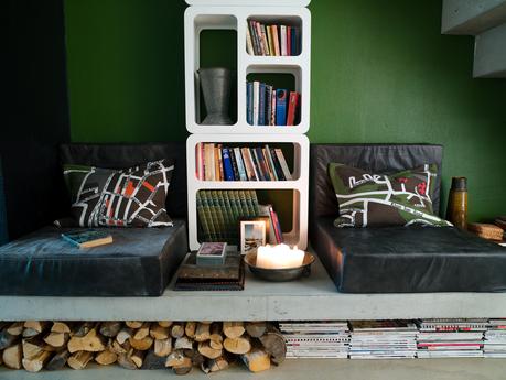 The reading corner can be turned into an extra bed. Schonning designed the leather poufs himself, and made the cushions from an Ikea carpet. Under the concrete slab there is room for wood, books and newspapers. Photo by     
    
      <p alt=