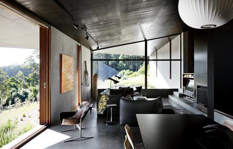 Living room with Arne Jacobsen AJ floor lamp, Le Bambole sofa in home designed by Kirsten Thompson Architects.