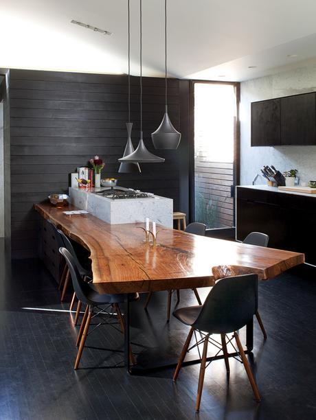 Modern dining room with walnut slab dining table and Tom Dixon Beat lamps