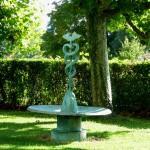 Fountain with caduceus by Meret Oppenheim in the garden