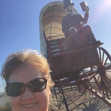Cheryl Boglioli on Route 66 with Worlds Largest Covered Wagon