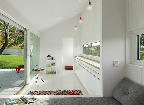 modern guesthouse in norway with angular facade and interior with Thomas Bentzen table, Hay cushions, and Muuto pendant lamps