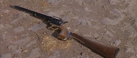 Col. Mortimer in For a Few Dollars More Colonel Mortimer should really invest in a gun rack or at least some form of storage rather than just leaving his pieces on the ground.