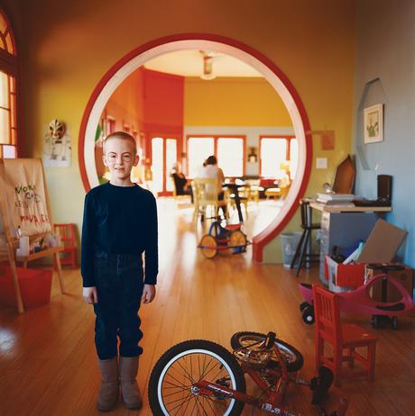 Moe stands in front of the circular opening between the living area and the sleeping/bath quarters.