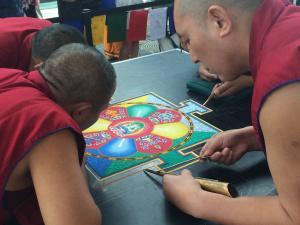 Tibetan Buddhist monks make a sand mandala
