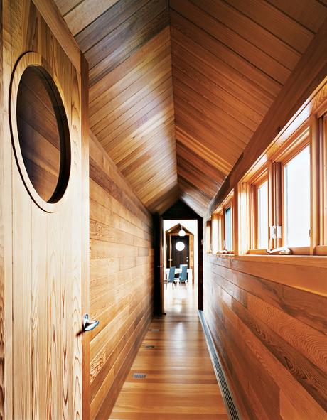 The view from the master bedroom down the long cedar corridor into the living room is one of the home’s real pleasures.