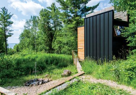 Steel cladding and outdoor fire pit of Wisconsin cabin by Revelations Architects/Builders.