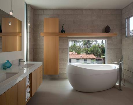 Bathroom with plentiful windows and deep tub. 