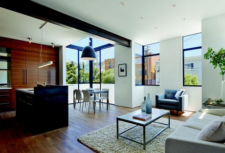 Living room with oak floors and CB2 Capitol Pendant Light in San Francisco renovation and addition by Zack | de Vito Architecture + Construction.