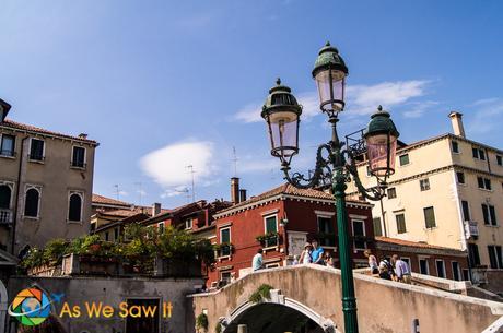 Tourists cross one of Venice's many bridges