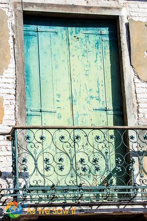 A weatherbeaten window balcony in Venice, Italy