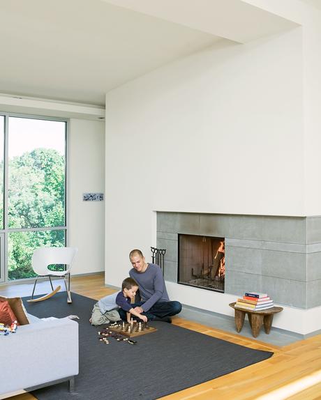 Christian and Jack play chess by the fireplace - the centerpiece of the living room and which the Arnolds use daily during the winter. The hearth is made of large slabs 
of limestone, which Christian cut himself, intentionally leaving imperfections on the
