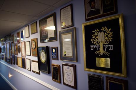 Another wall covered with awards and testimonials for speaking engagements 