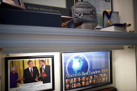 Framed pics of Carson receiving Medal of Freedom award from Bush, and cover of magazine featuring Carson.