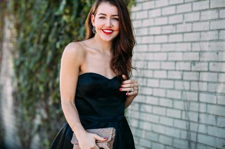 Amy Havins wears a black party dress from the David's Bridal holiday 2015 collection.