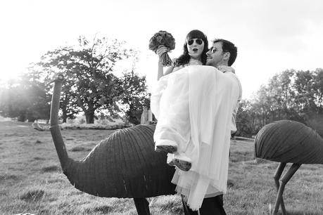bride & groom pose on emus at Langar Hall Wedding