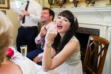Bride laughs during best man speech