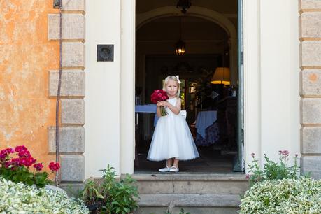 Langar Hall Wedding Photography little bridesmaid in the door holding red roses
