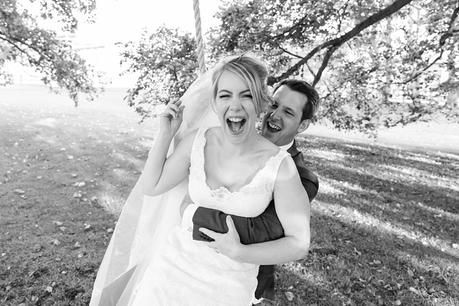 Bride sitting on groom's lap on swing Barmbyfield Barn Wedding Photography