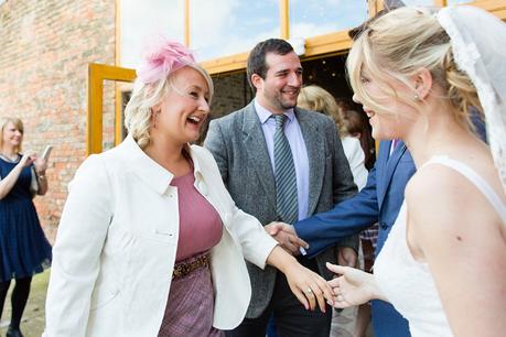 Candid hugs with guests Barmbyfield Barn Wedding