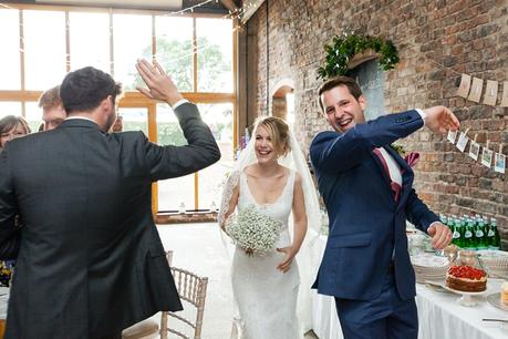 Bride & groom high 5 entrance Barmbyfield Barn Wedding Photography