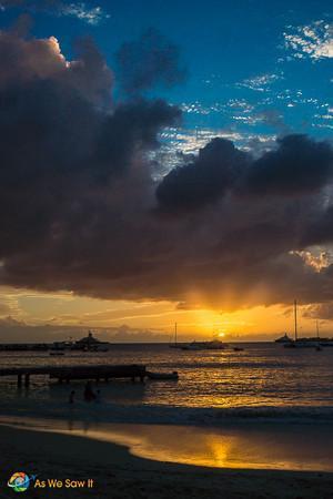 The sky deepens as the golden sun disappears off St. Martin's coast