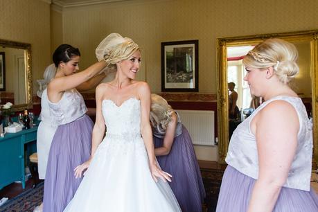 Bride gets into wedding dress at Crow Hill Wedding Tux & Tales Photography