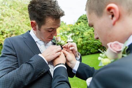 Groom puts on buttonhole at Crow Hill Wedding